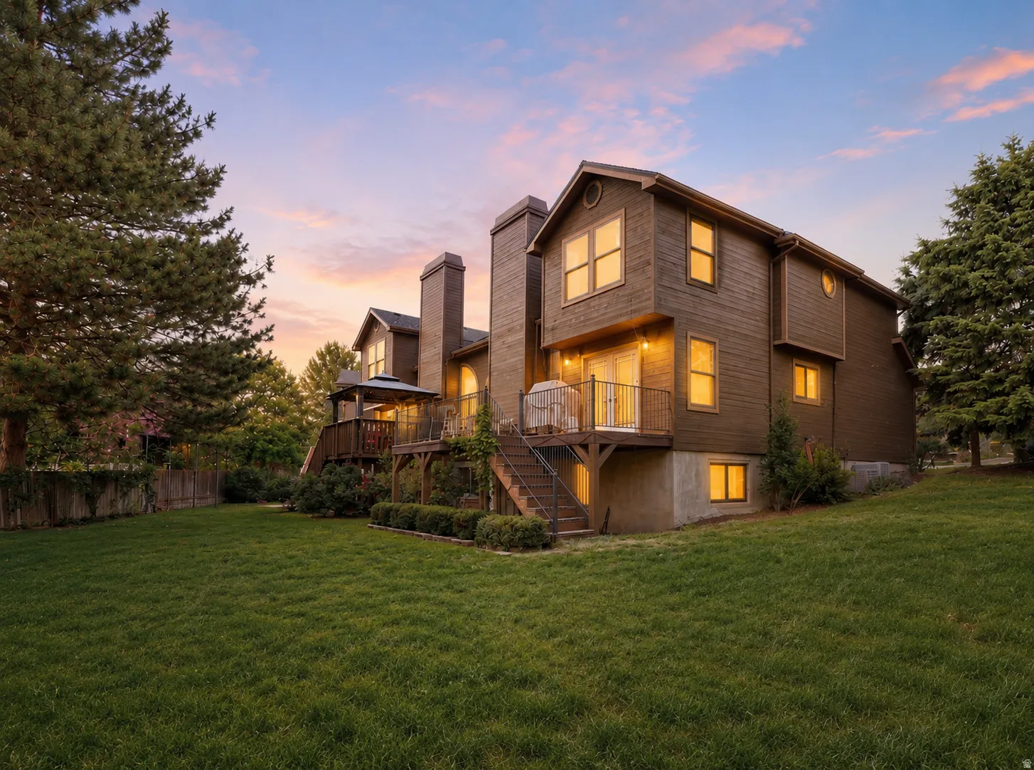 Expansive backyard with a manicured lawn and mature trees
