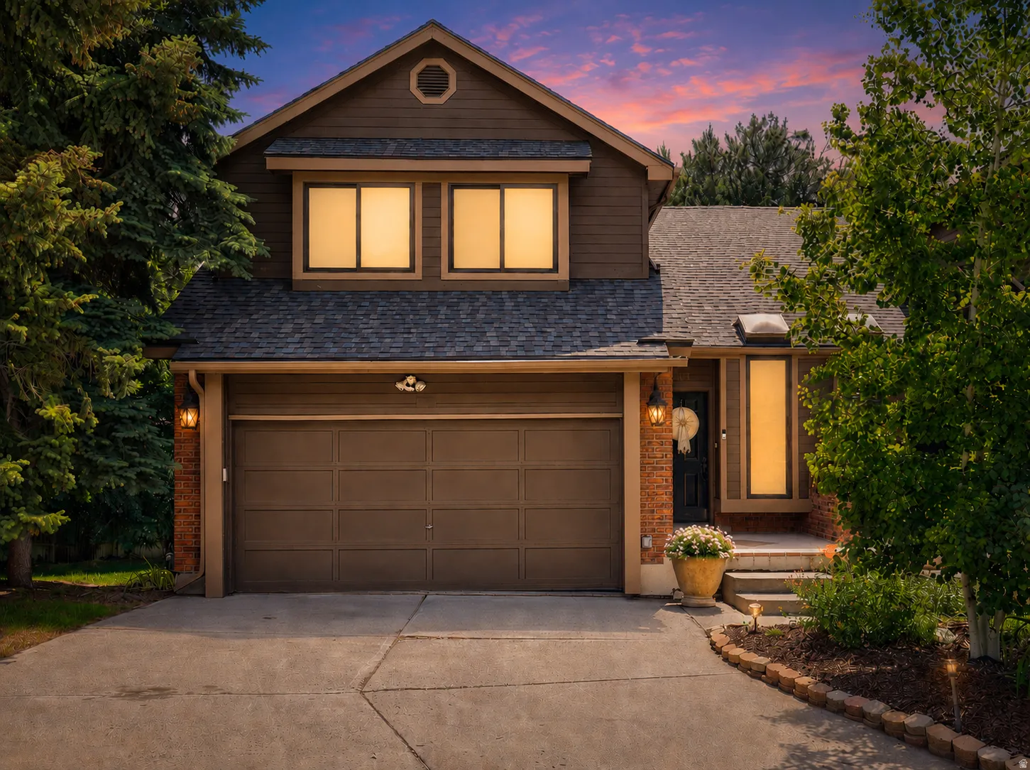 Front exterior featuring brown siding and brick accents