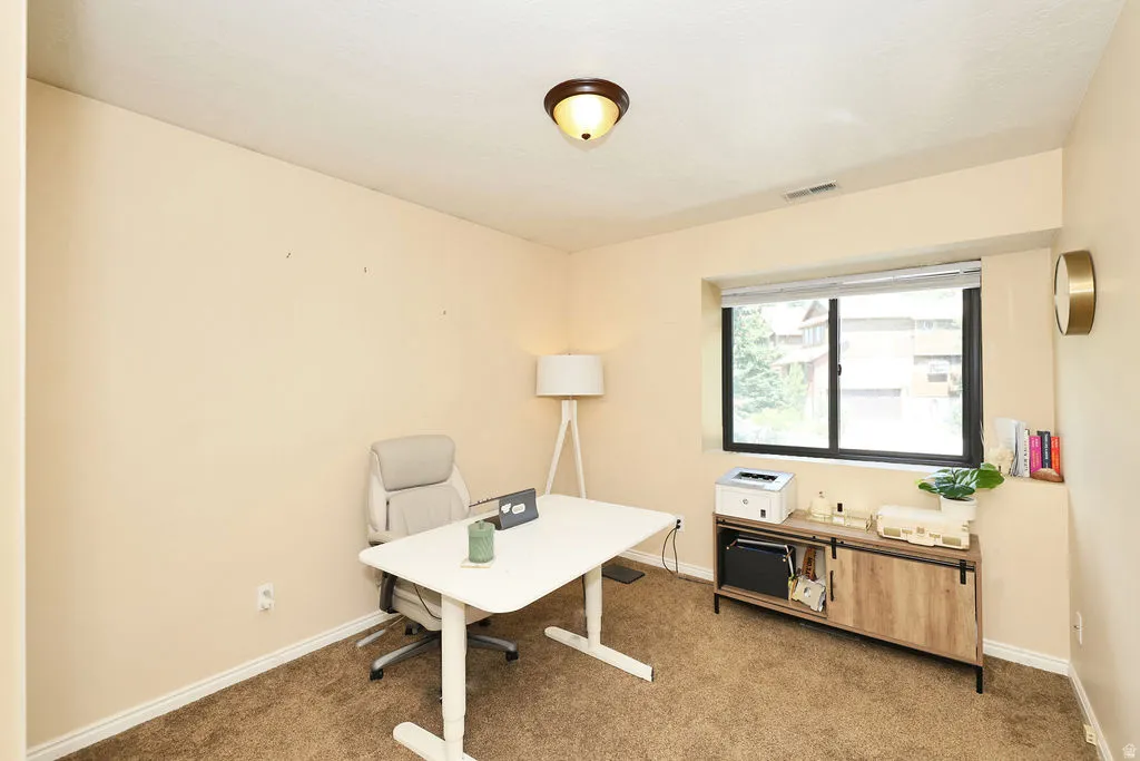 Second floor bedroom (3 of 3 up). Room with carpet flooring and a large window