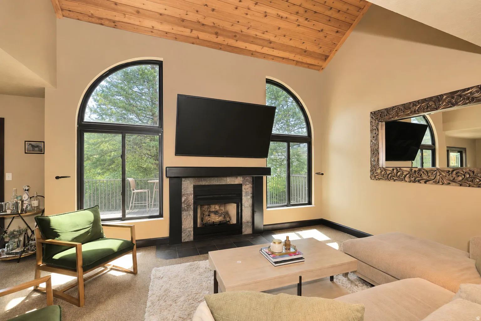Vaulted wood-finish ceiling above a stone-surround fireplace with a dark wood mantel