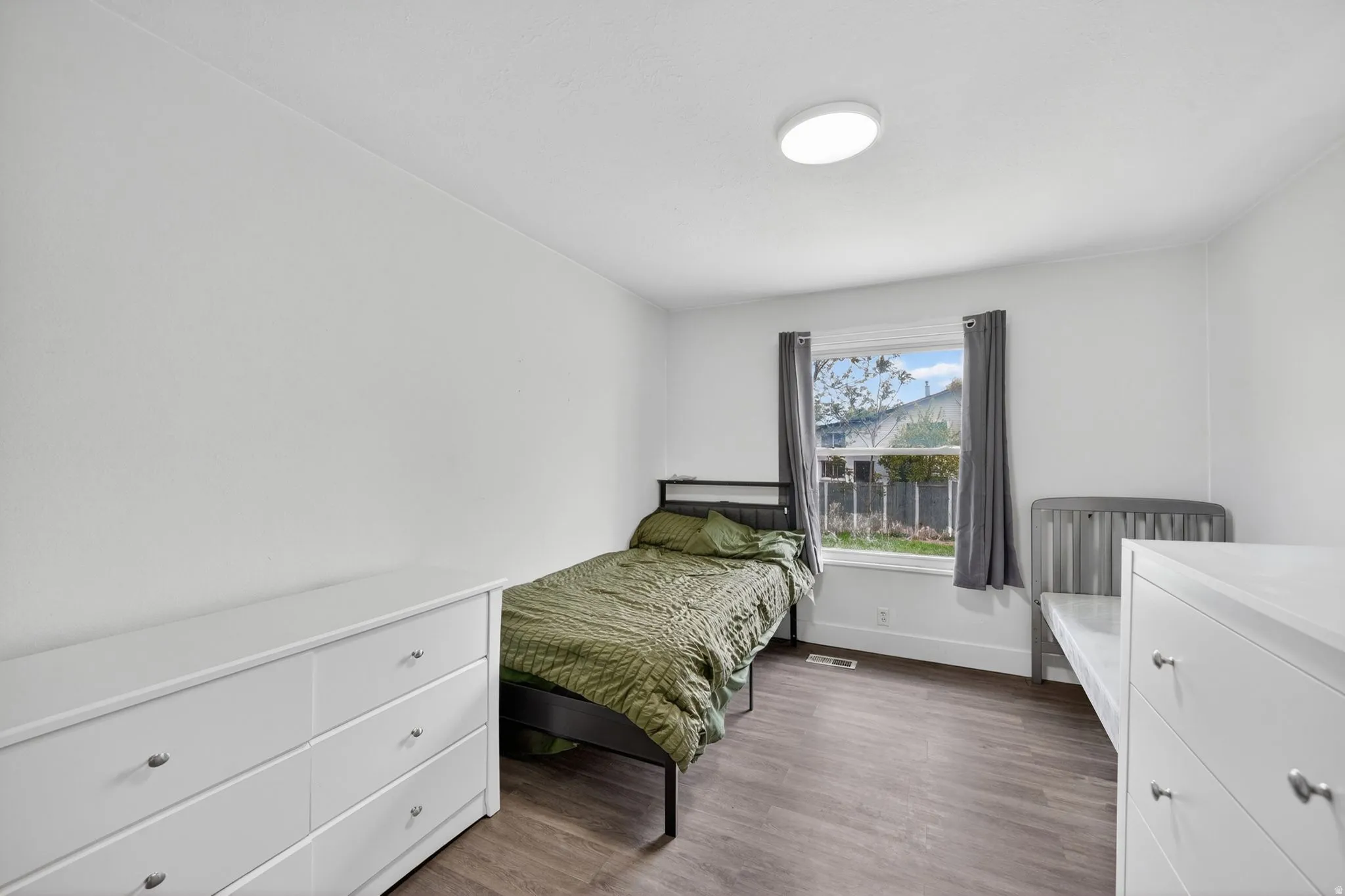 Neutral white walls with wood-finish flooring