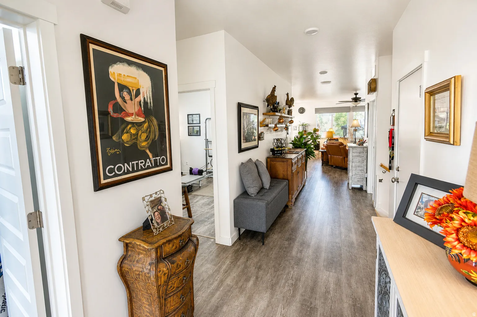 Inviting hallway entry featuring wood-finish flooring, recessed lighting, white walls, and a clear line of sight to the main living area
