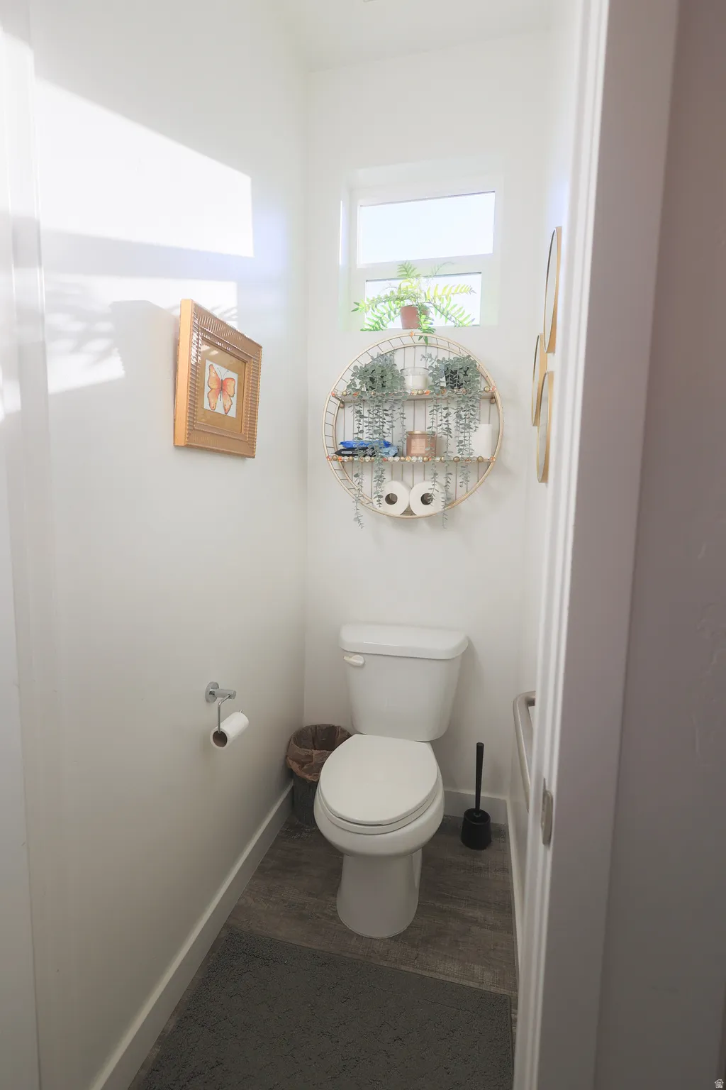 Master Powder room featuring a single toilet, waterproof luxury vinyl plank flooring, and a transom window
