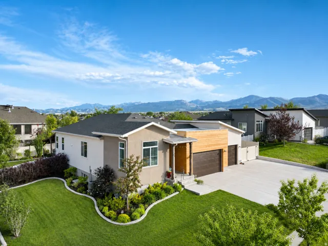 Contemporary residence featuring a stucco and horizontal wood-finish facade