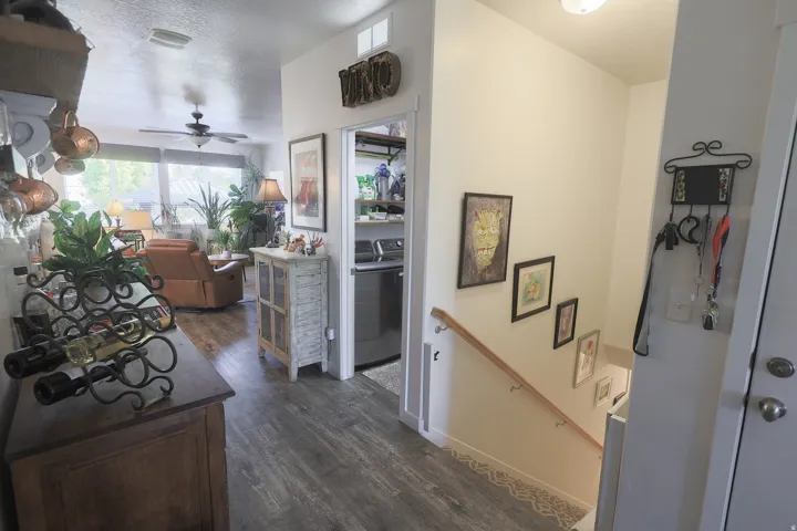 Open floor plan featuring waterproof luxury vinyl plank flooring, a ceiling fan, and a wide window offering exterior views