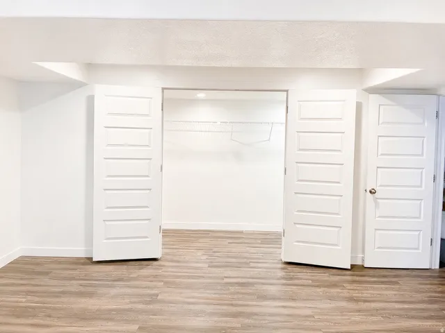 Spacious room featuring waterproof luxury vinyl plank flooring, white walls, and recessed lighting