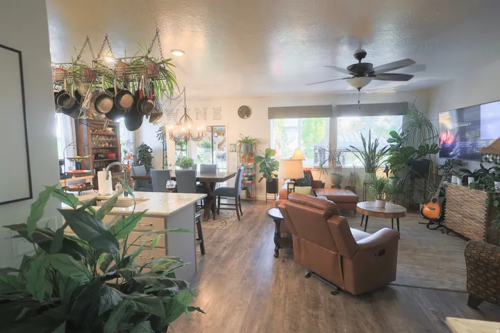 Open-concept interior featuring waterproof luxury vinyl plank flooring, recessed lighting, and large windows
