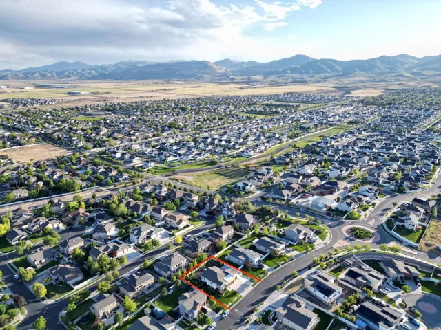 Aerial perspective of a residential neighborhood with distant mountain scenery