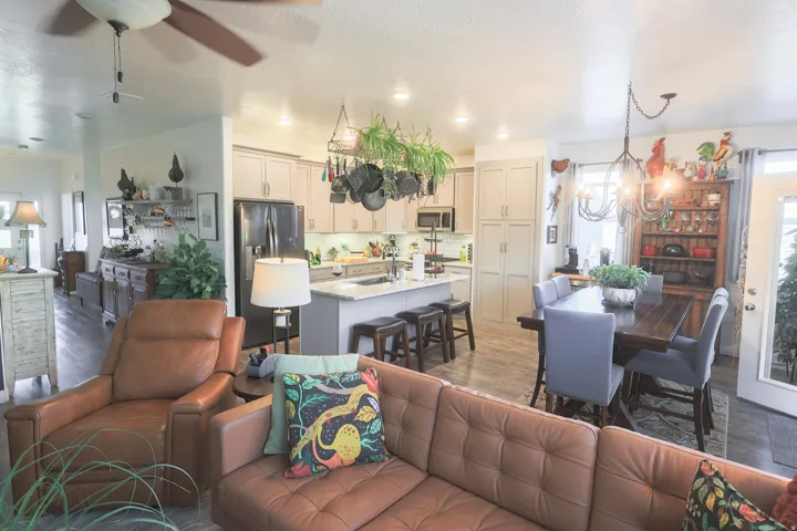 Open-concept living space featuring waterproof luxury vinyl plank flooring, recessed lighting, and a ceiling fan