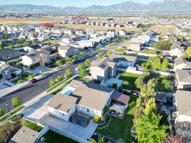 Expansive rear yard featuring a covered patio, large gazebo, and a fire pit area