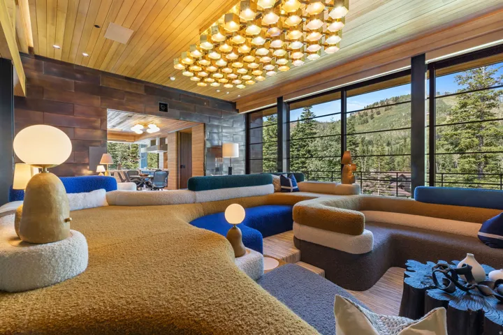 Expansive living area featuring a wood-panel ceiling and an ornate rectangular light fixture