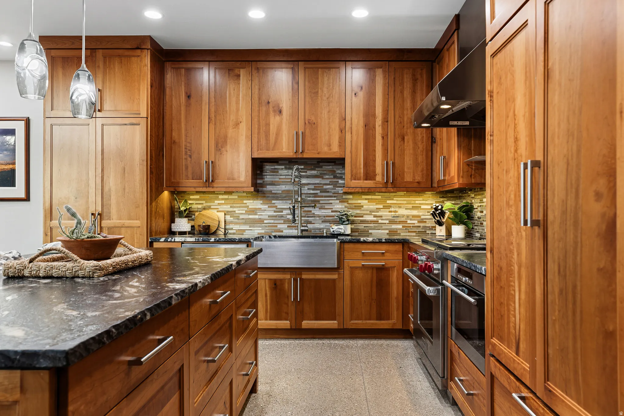 Kitchen island and bar seating shown toward the adjacent dining area, with cherrywood cabinetry throughout.