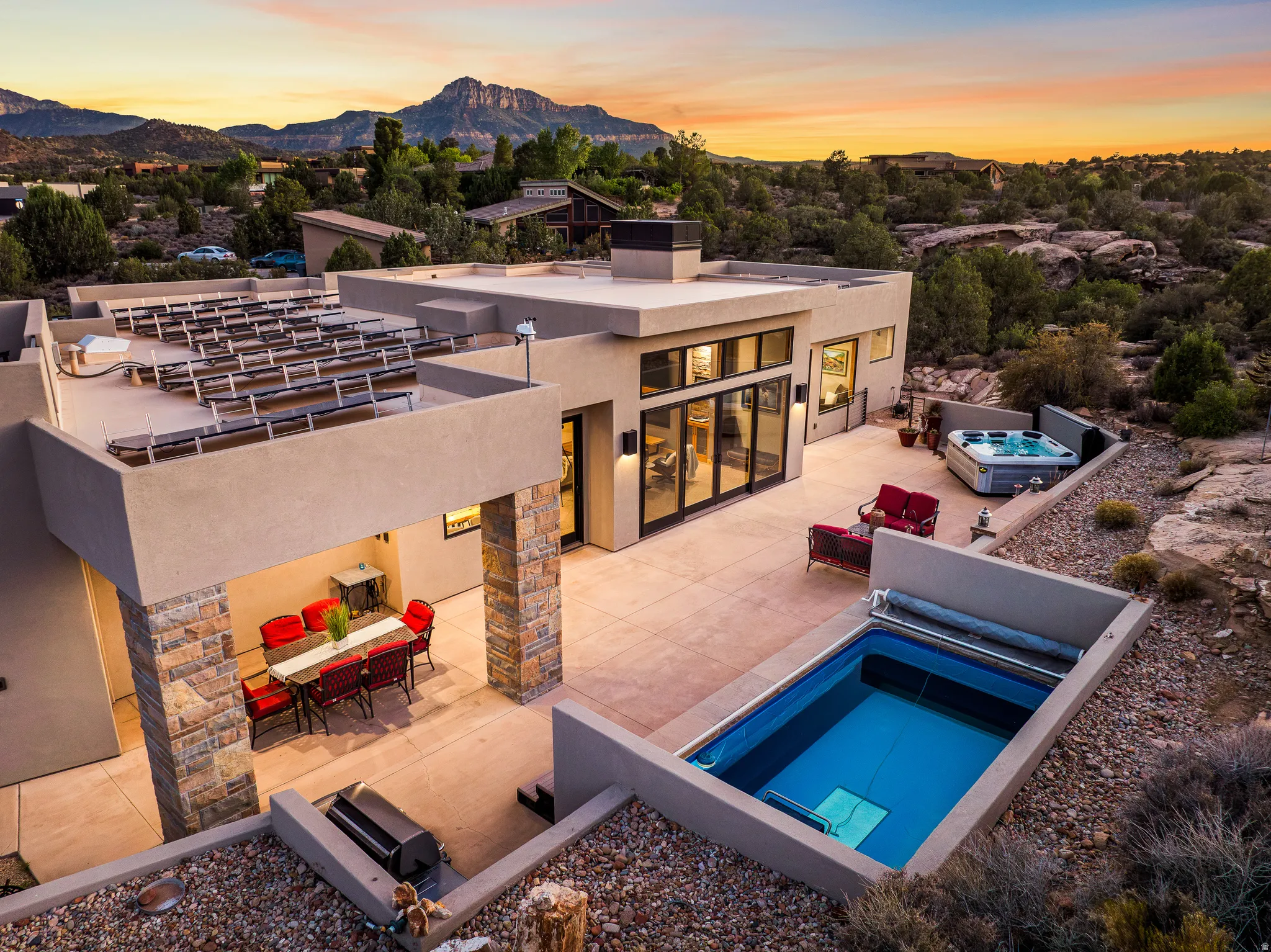 Contemporary property featuring a private outdoor pool, integrated hot tub, and an expansive upper-level patio