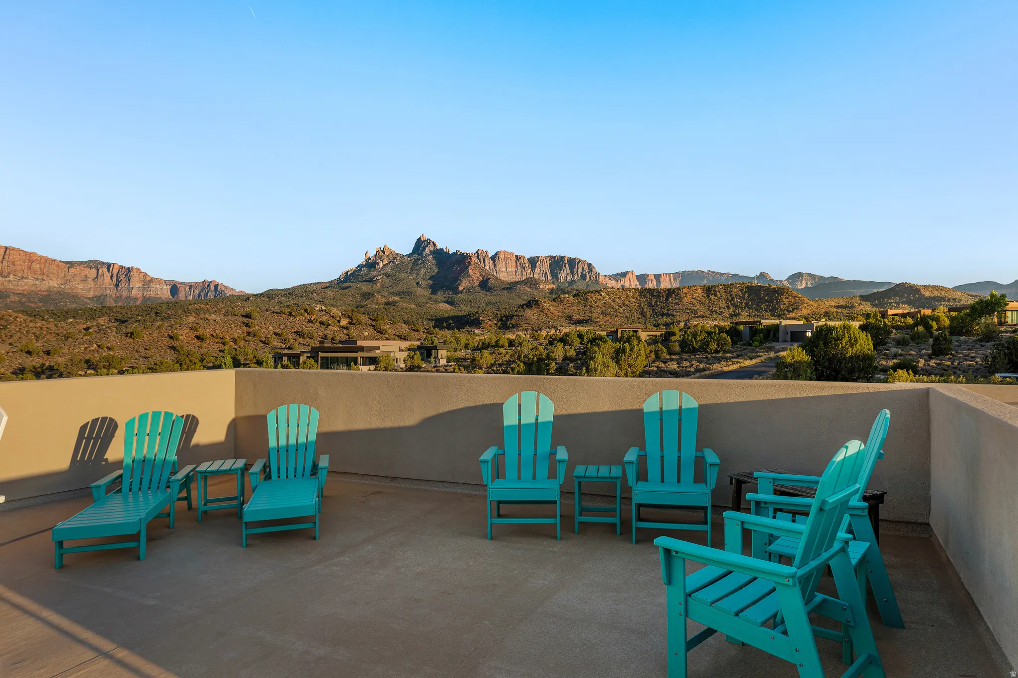 Rooftop deck seating oriented toward the red rock skyline.