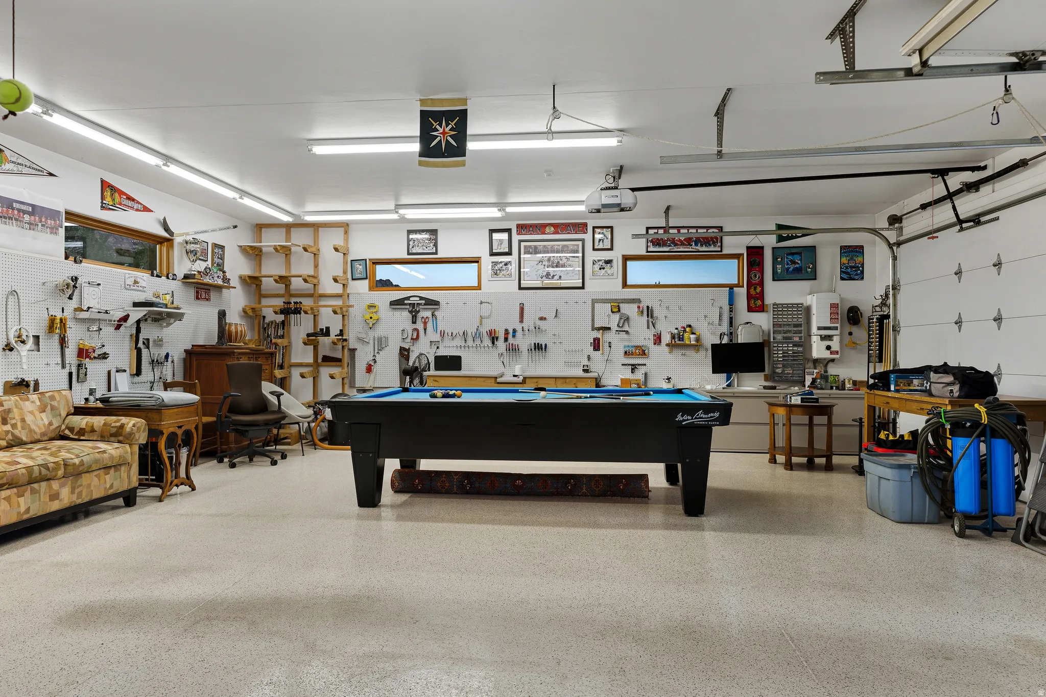 Garage interior set up with a recreation/game area and additional storage.