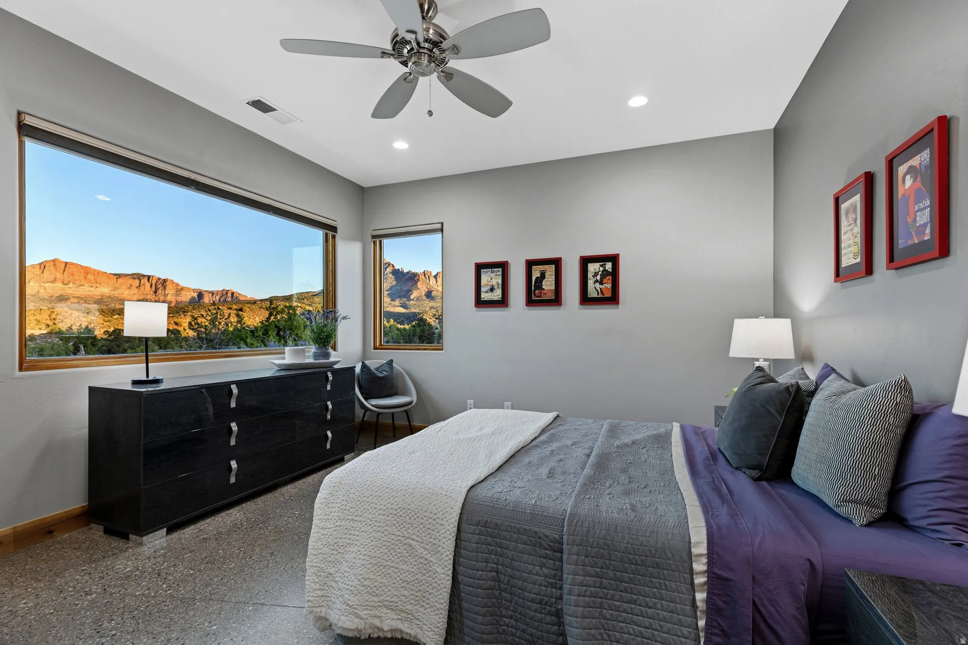 Expansive horizontal window framing distant red rock formations and natural landscapes