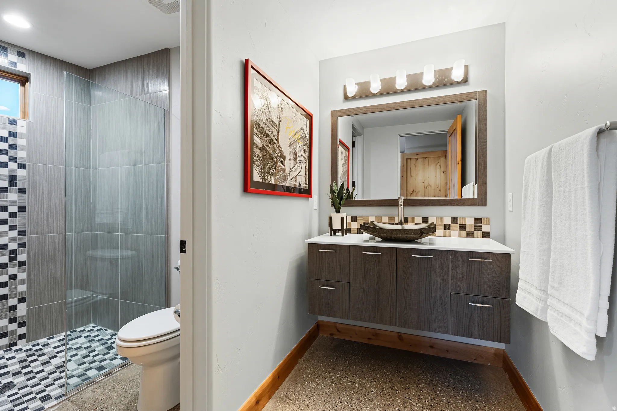 Full bathroom off of the third bedroom with vessel sink, mosaic tile accent, and a framed mirror.