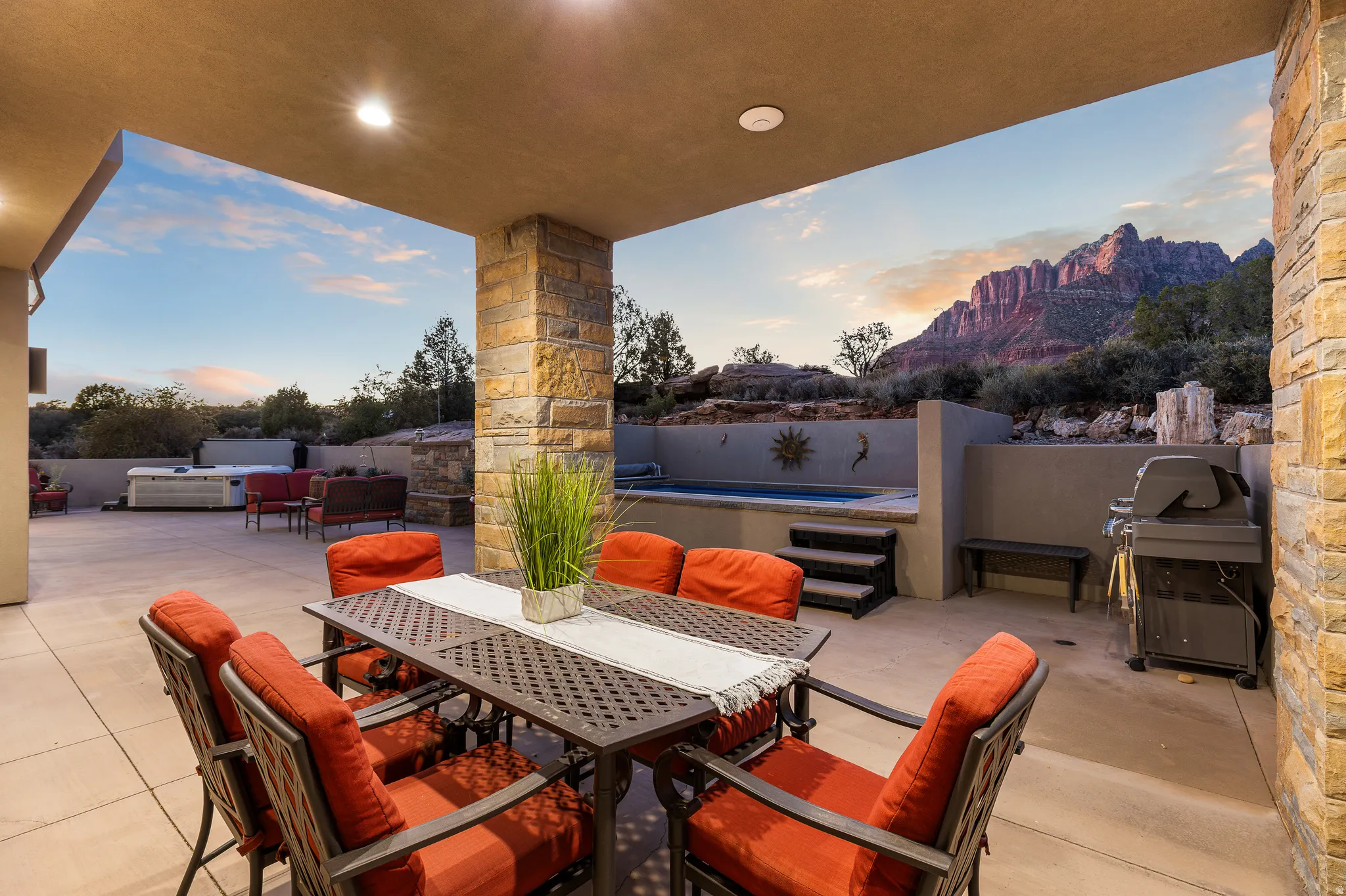Covered patio featuring a structured stone column, recessed lighting, and direct access to an outdoor spa and un-built hot tub area