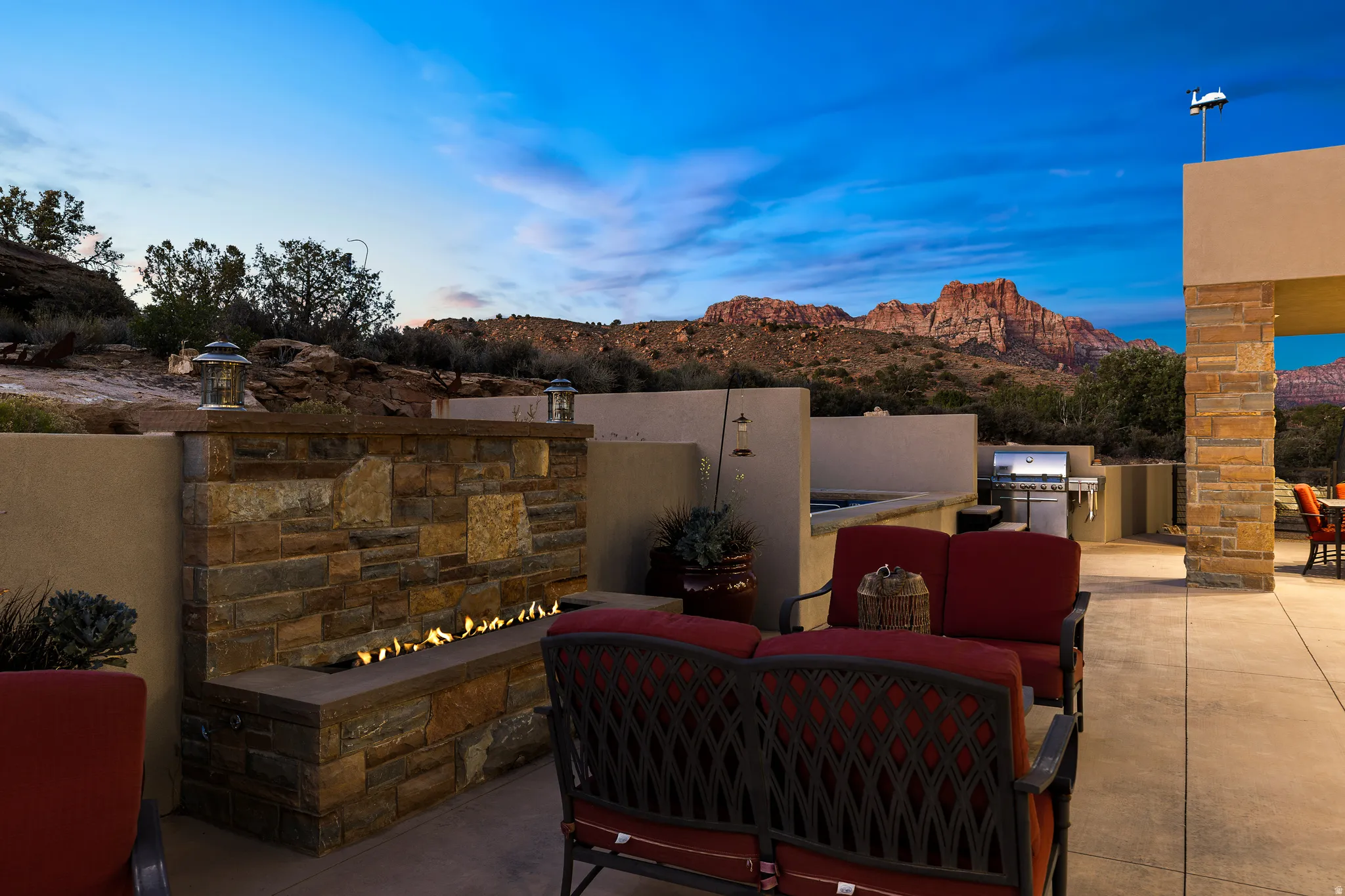 Outdoor living area with a fire feature and built-in seating.
