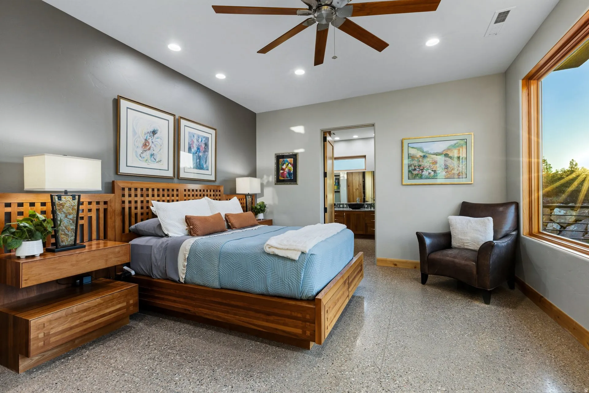 Spacious room featuring light gray walls, a contrasting dark gray accent wall, and polished concrete flooring