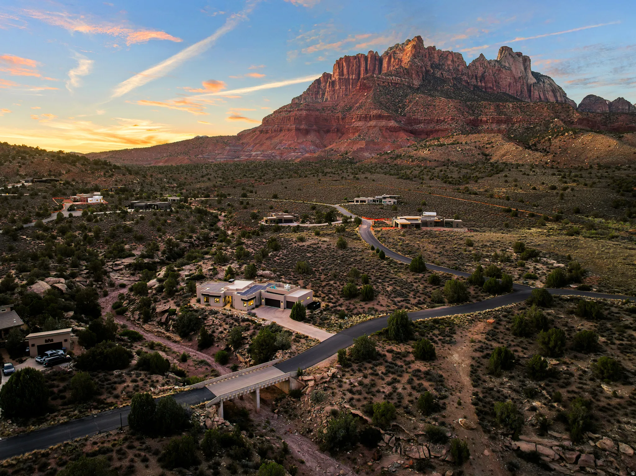 Aerial over the valley capturing the home's setting among the red rock formations.