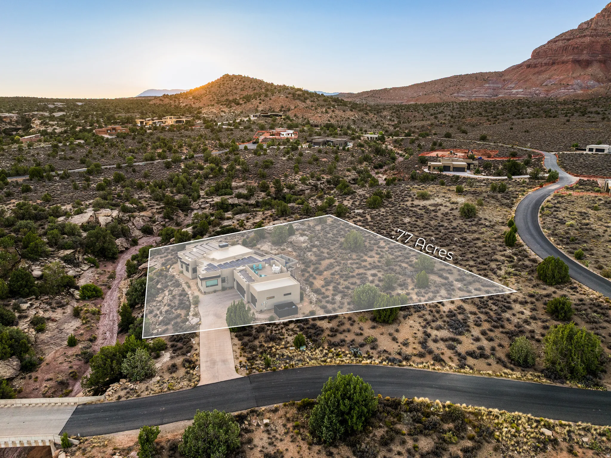Expansive desert landscape featuring a contemporary property on a .77-acre lot
