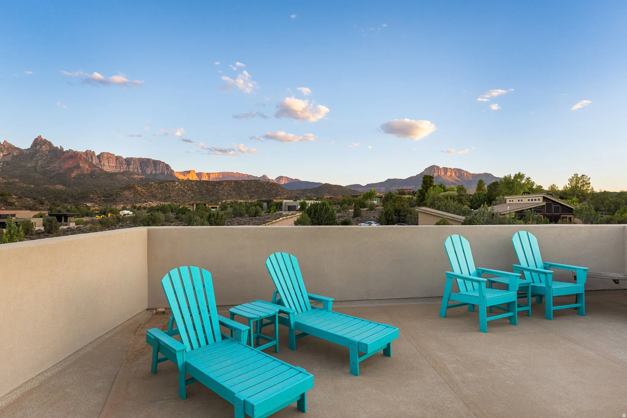 Rooftop patio featuring a low stucco wall and concrete flooring
