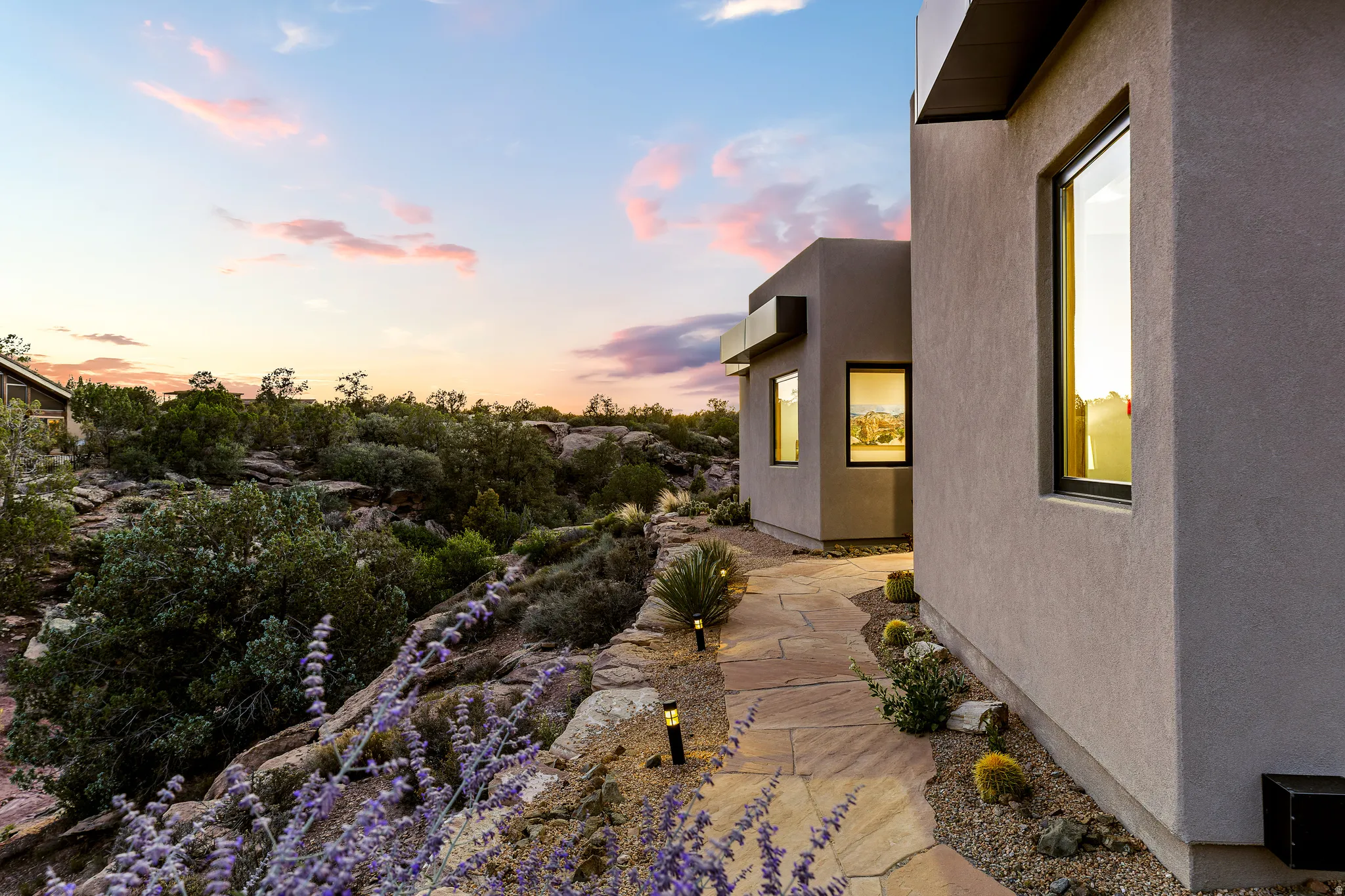 Modern exterior architecture with a stucco finish and contrasting dark trim