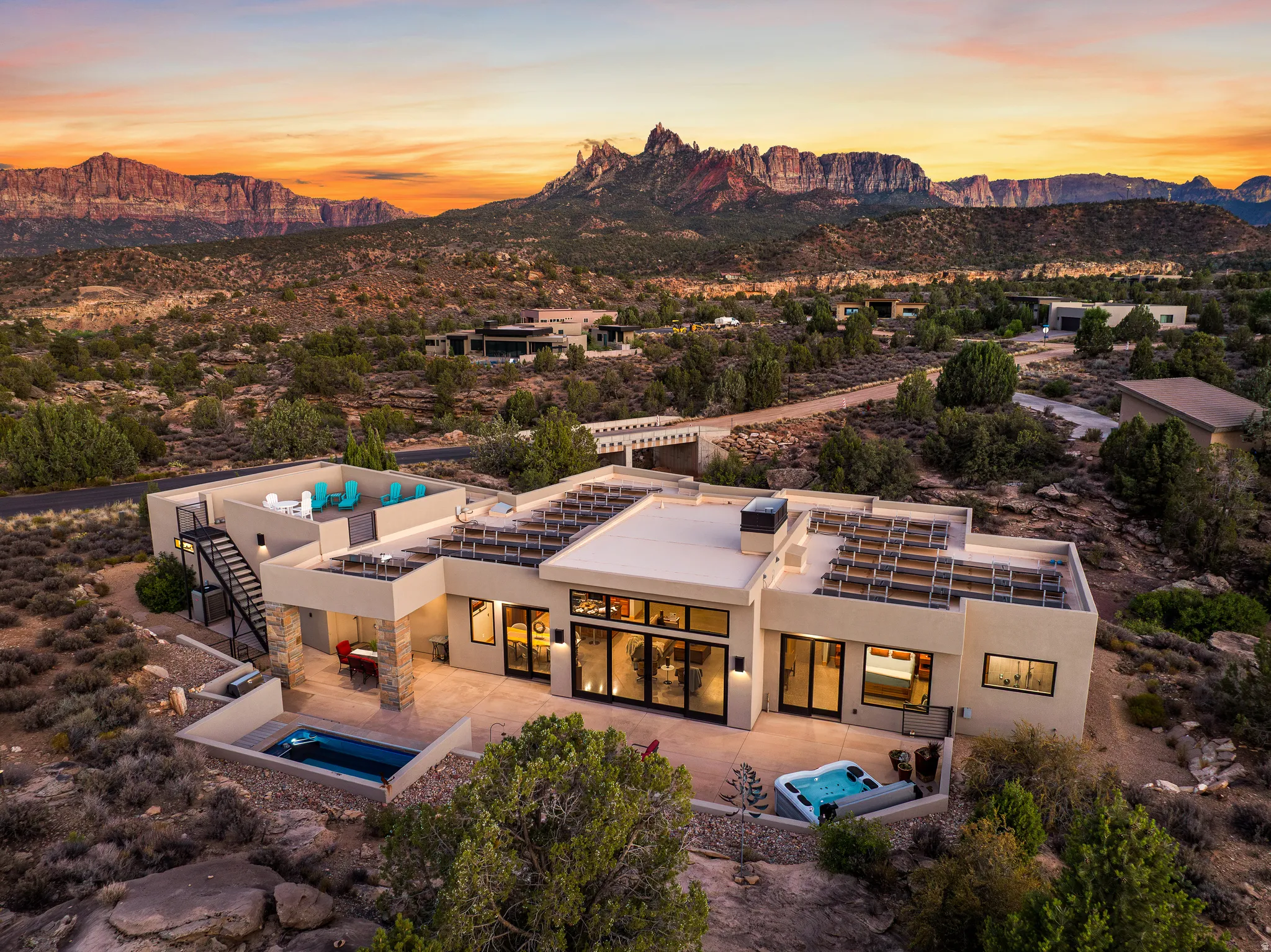 Contemporary desert residence featuring a flat roofline and a stucco exterior
