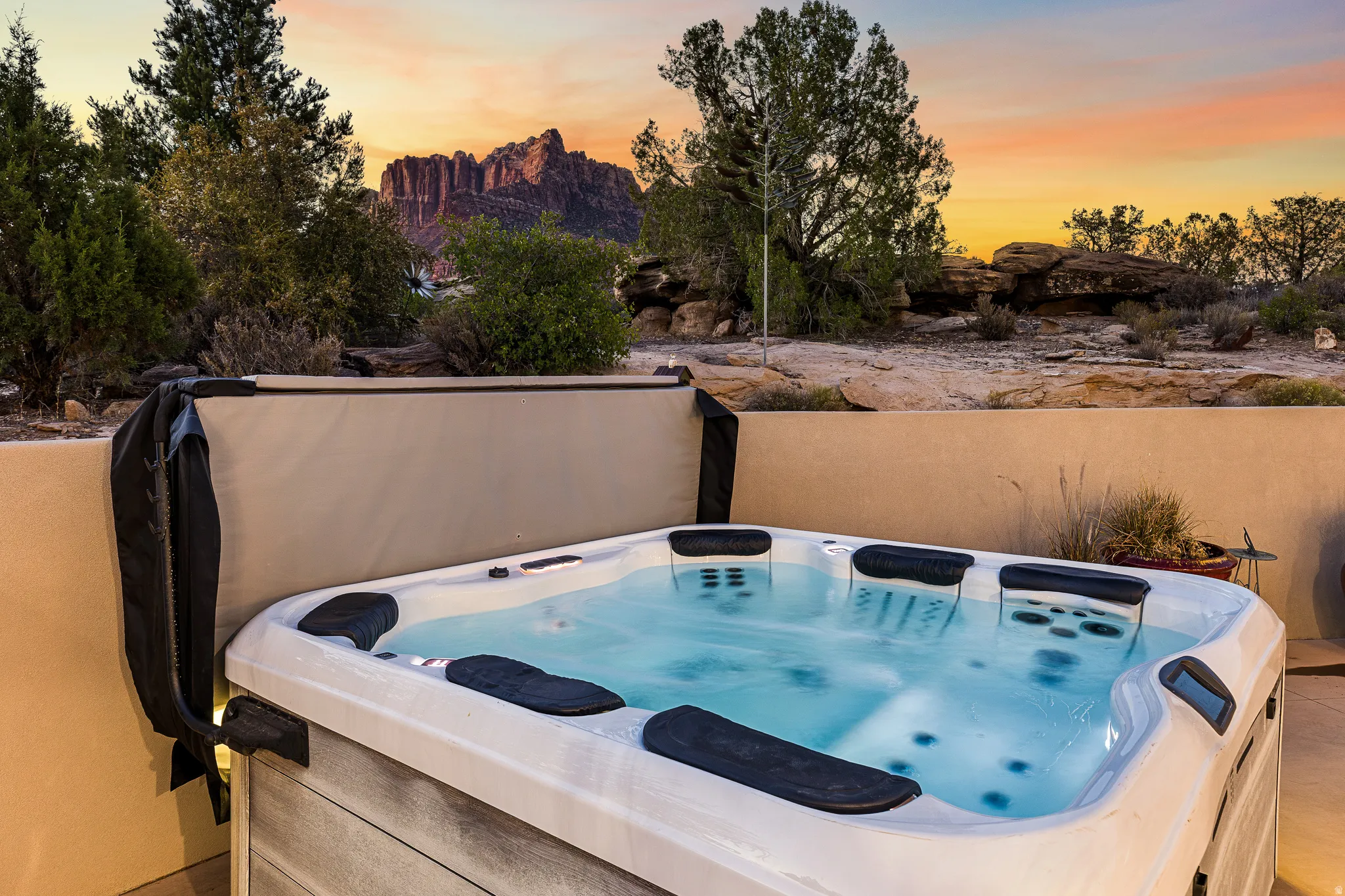 Outdoor spa with integrated seating, set on a tiled patio