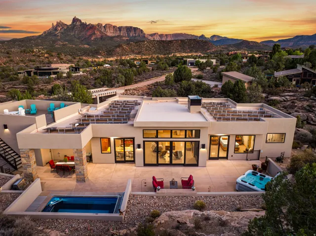 Modern residence featuring a flat roofline and extensive outdoor living spaces