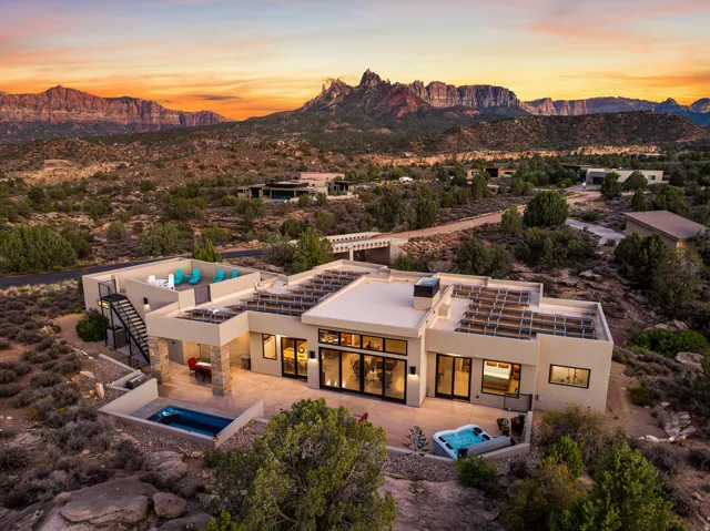 Contemporary desert residence featuring a flat roofline and a stucco exterior