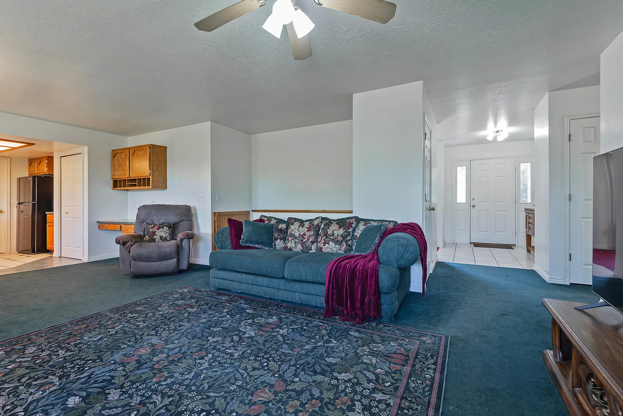 Spacious interior featuring wall-to-wall carpeting and white trim