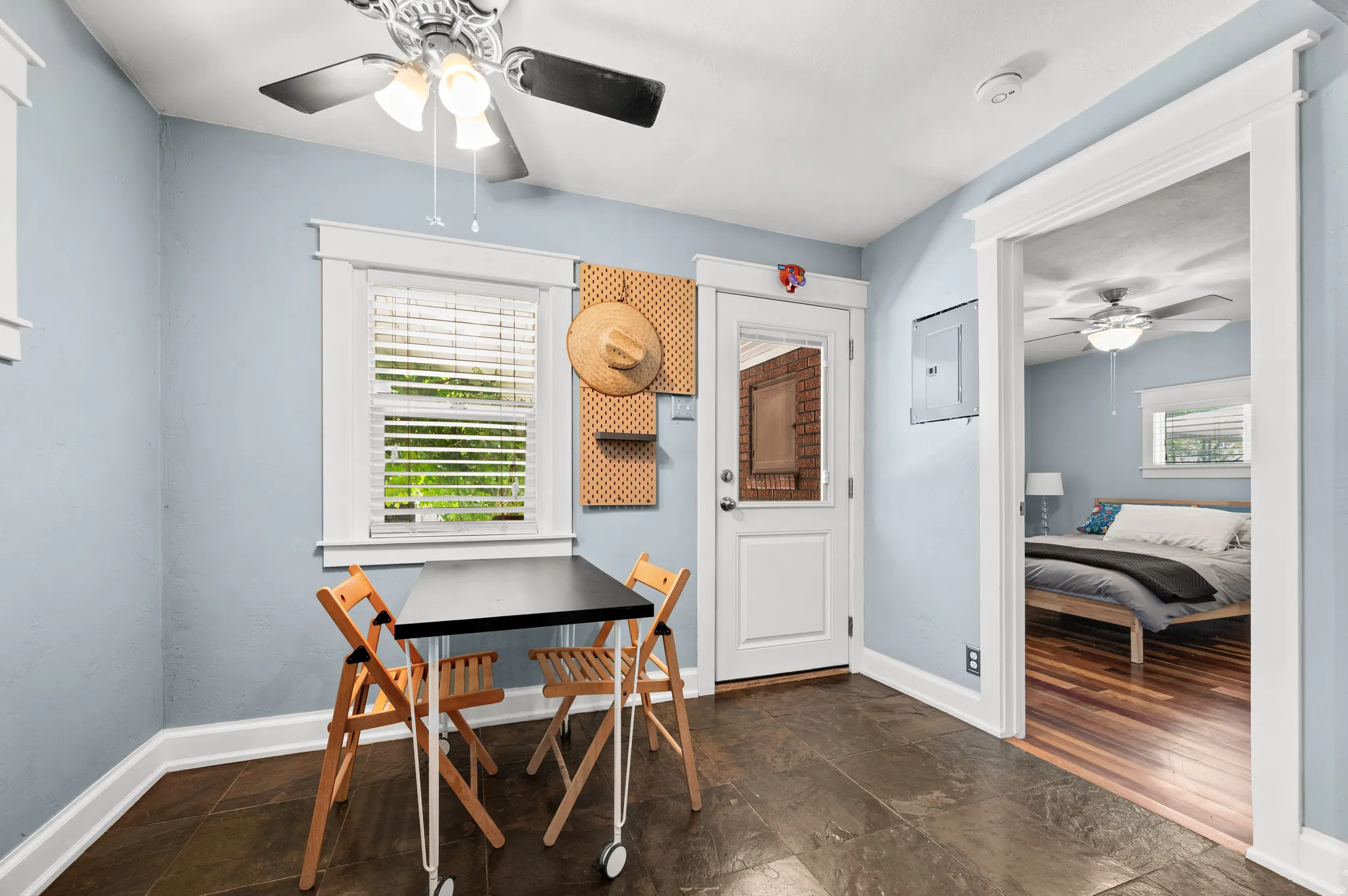 Dining room with a ceiling fan, door to the back deck and patio