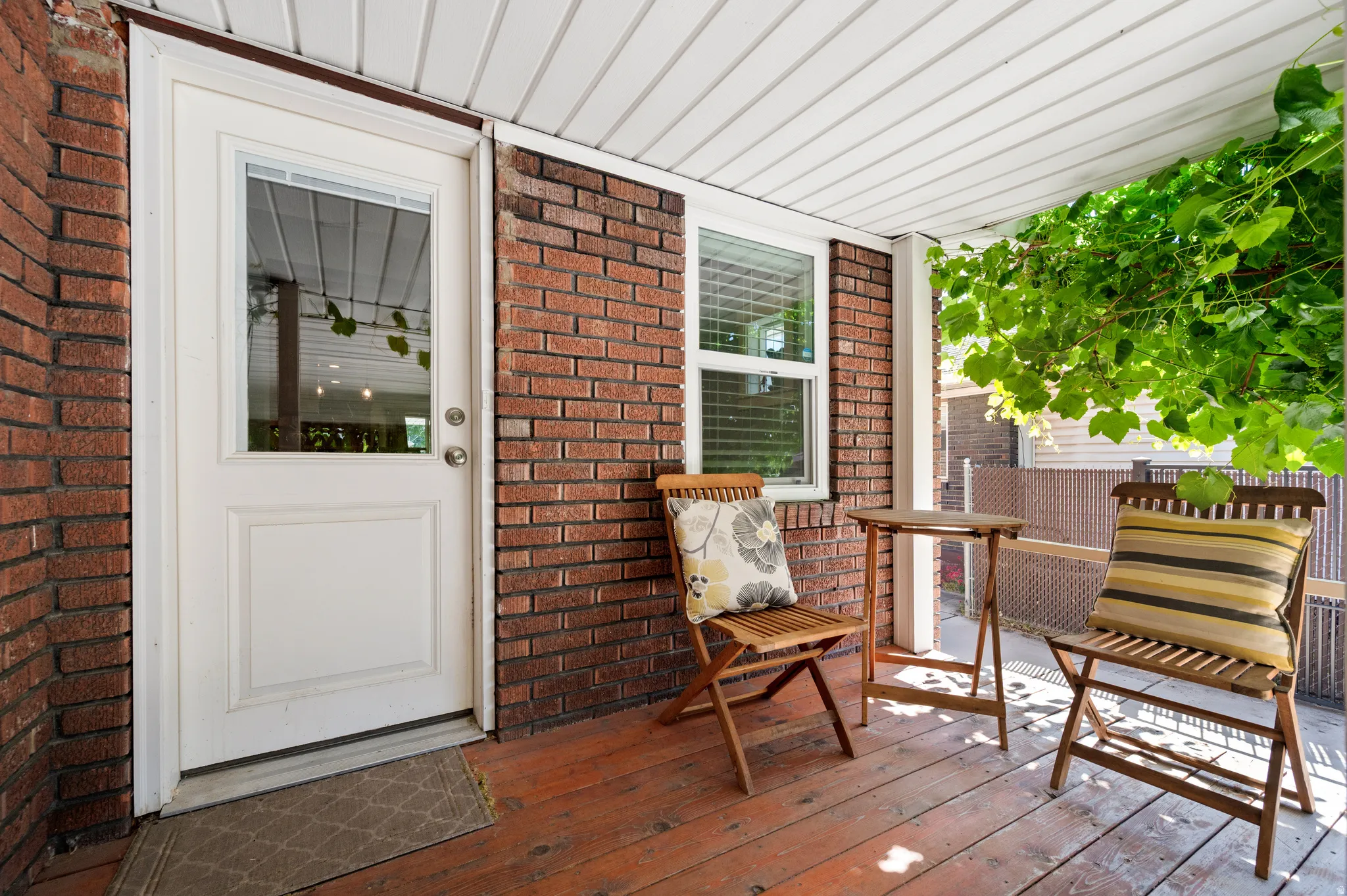 Covered outdoor deck with door to kitchen