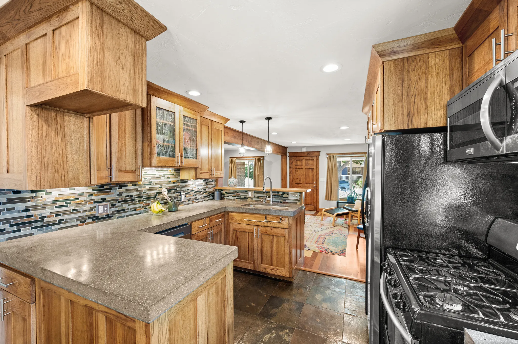 Kitchen featuring wood cabinetry, gas stove, built in microwave