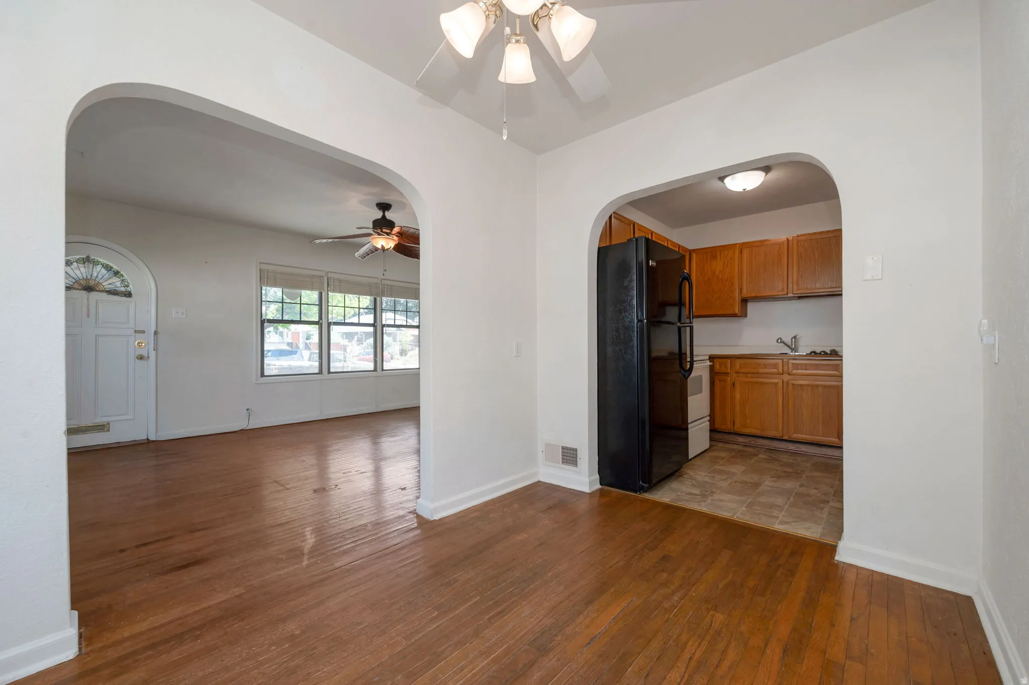 Interconnected living spaces featuring warm wood-finish flooring