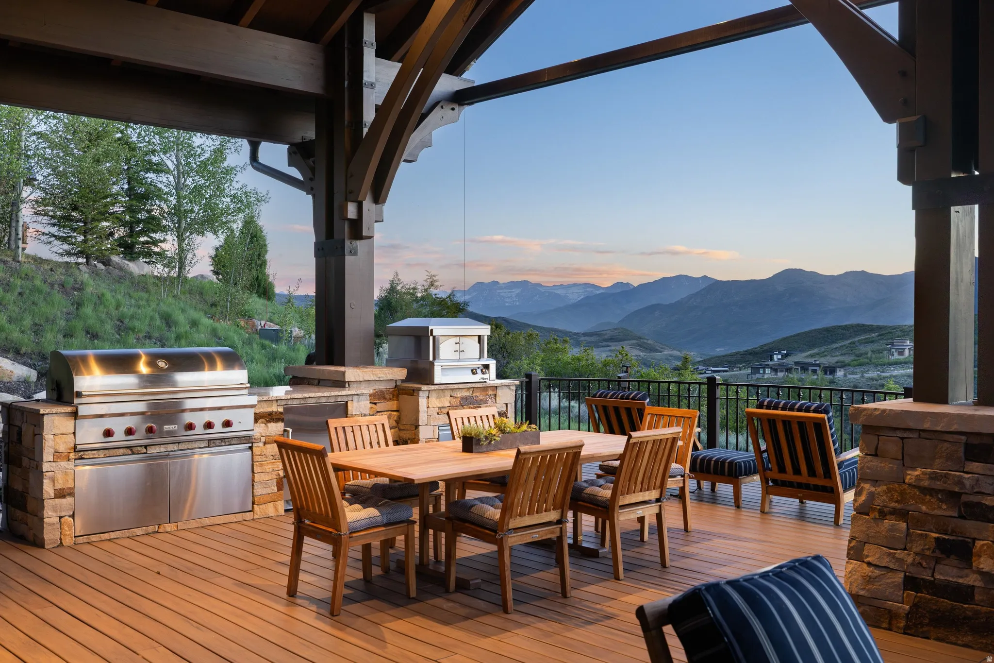 Expansive outdoor deck with wood-finish flooring and a mountain backdrop