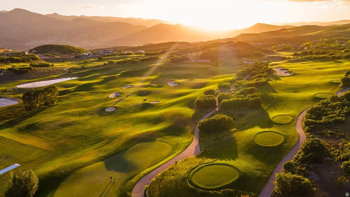 Expansive golf course landscape featuring multiple greens, sand traps, and cart paths