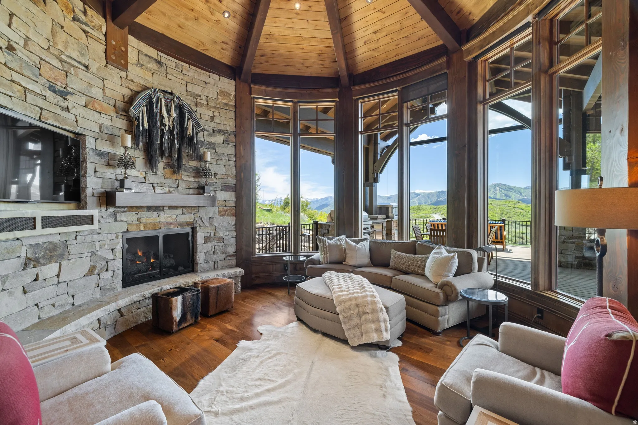 Living area featuring a stone-clad fireplace and a built-in media cabinet