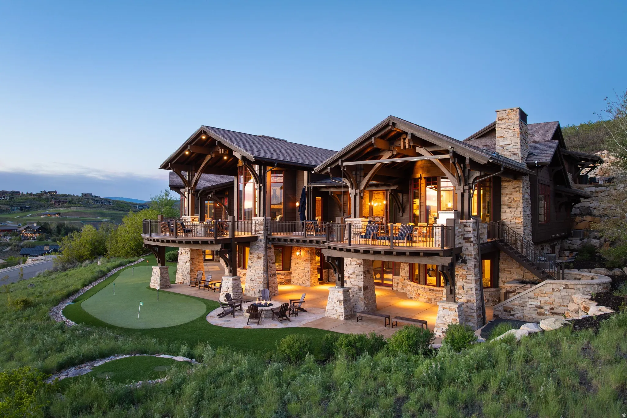 Multi-level architectural design featuring extensive stone and wood construction