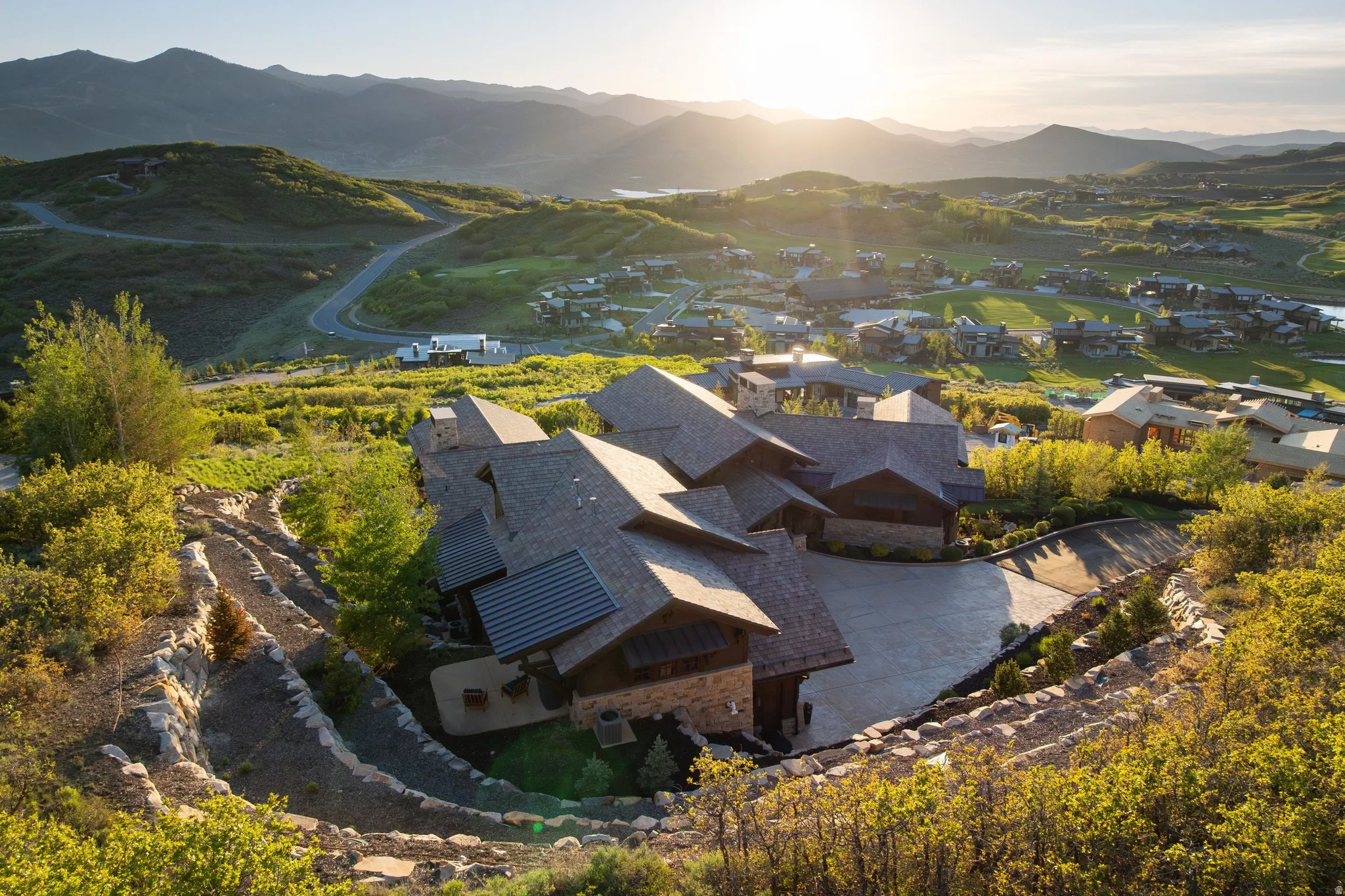 Mountain modern residence featuring multiple gables and a stone facade