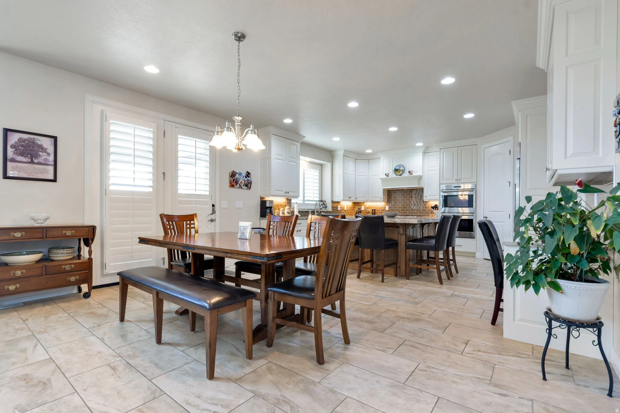 Open-concept kitchen and dining area featuring light tile flooring throughout