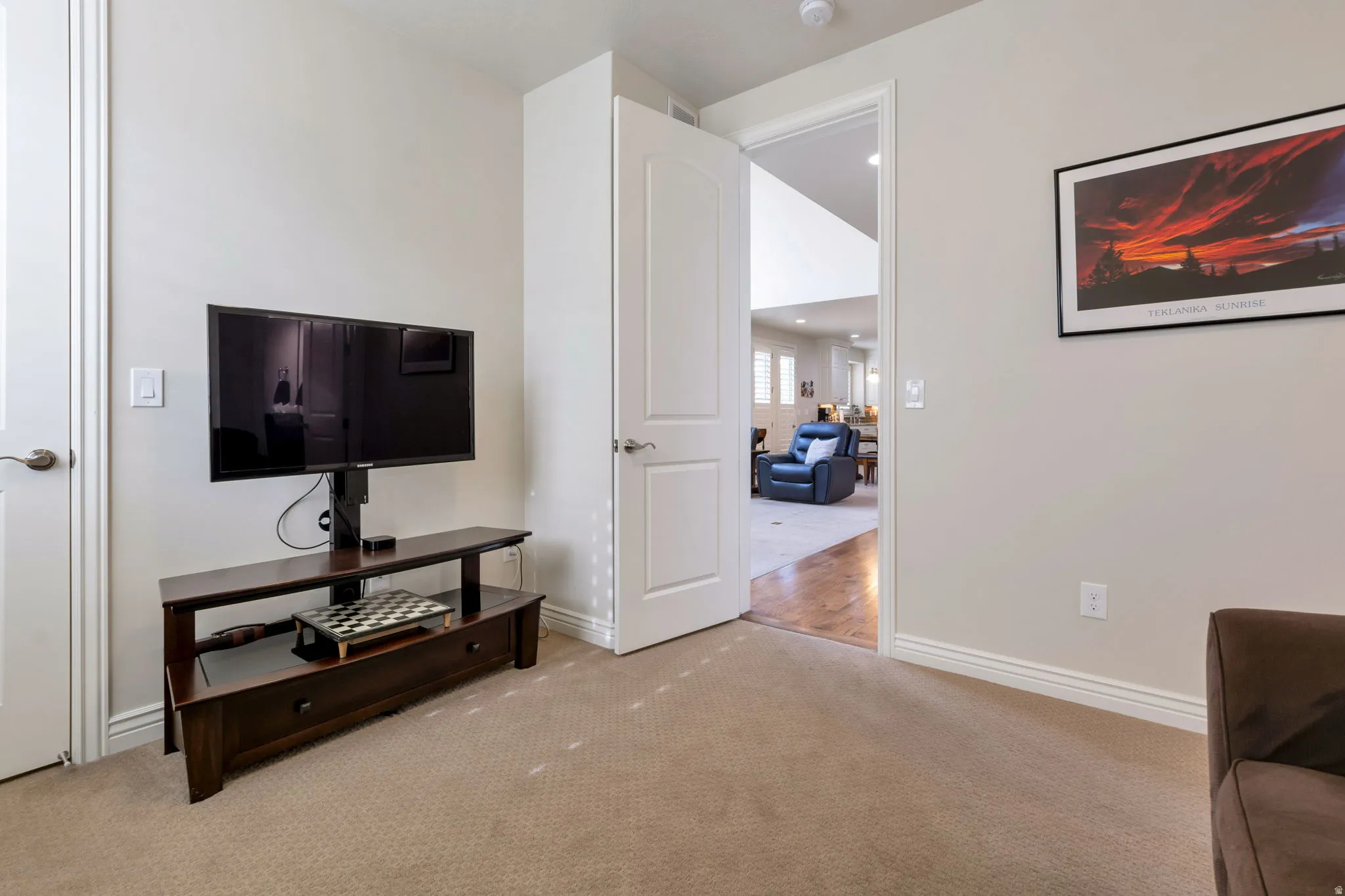 Carpeted interior space with light-toned walls and white trim