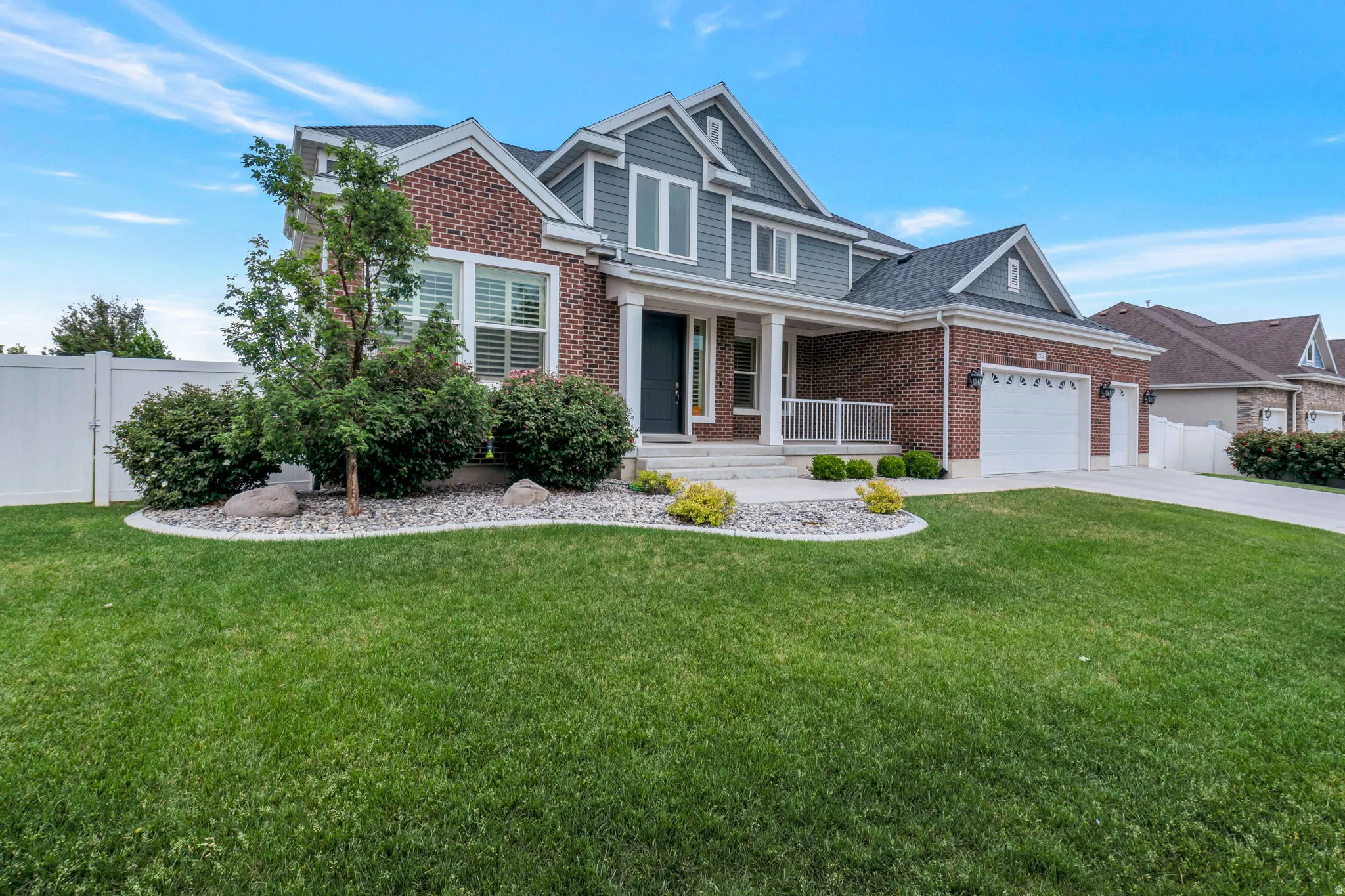 Traditional style residence featuring a brick and siding exterior