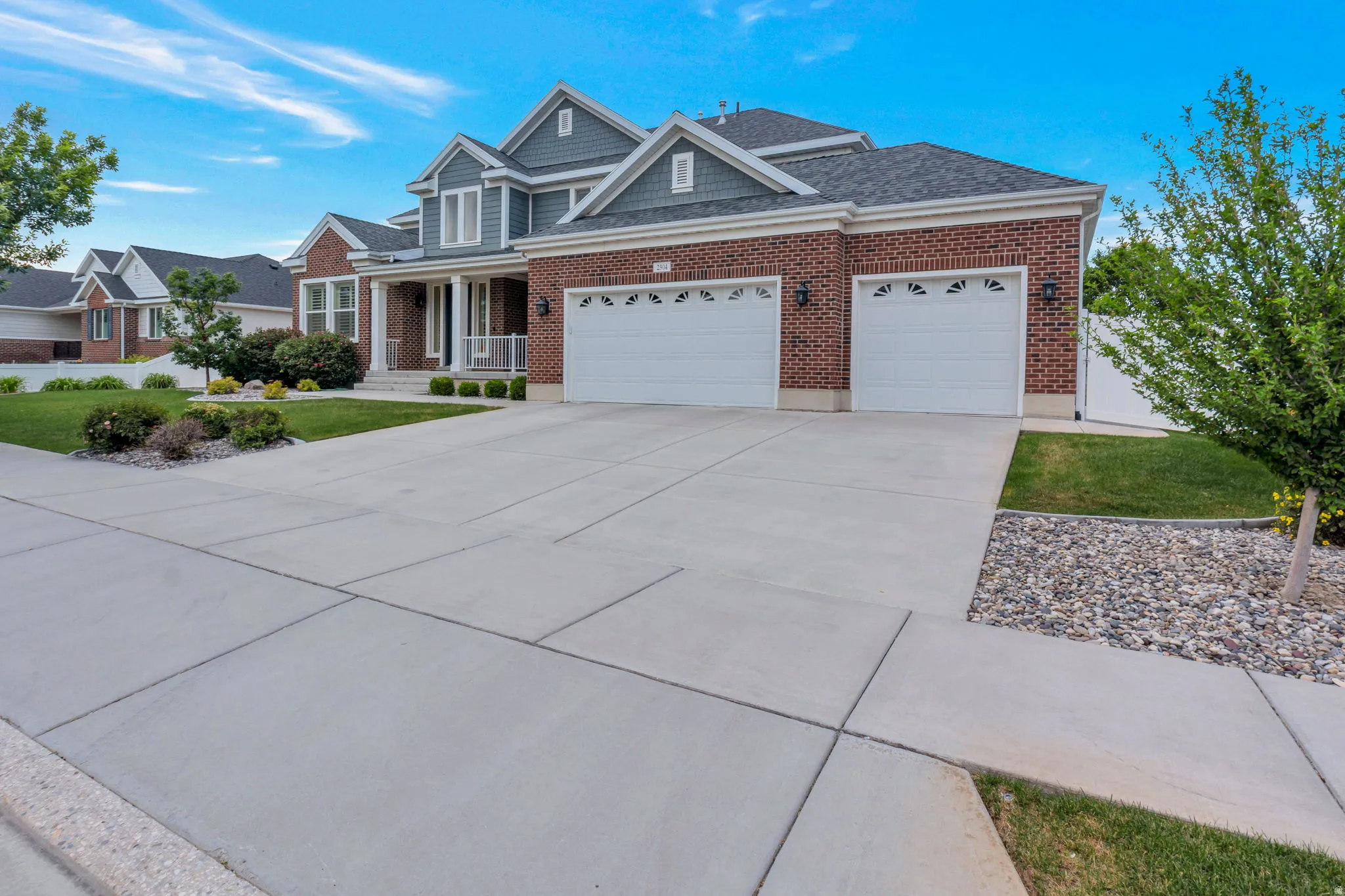 Brick and siding exterior featuring gabled rooflines
