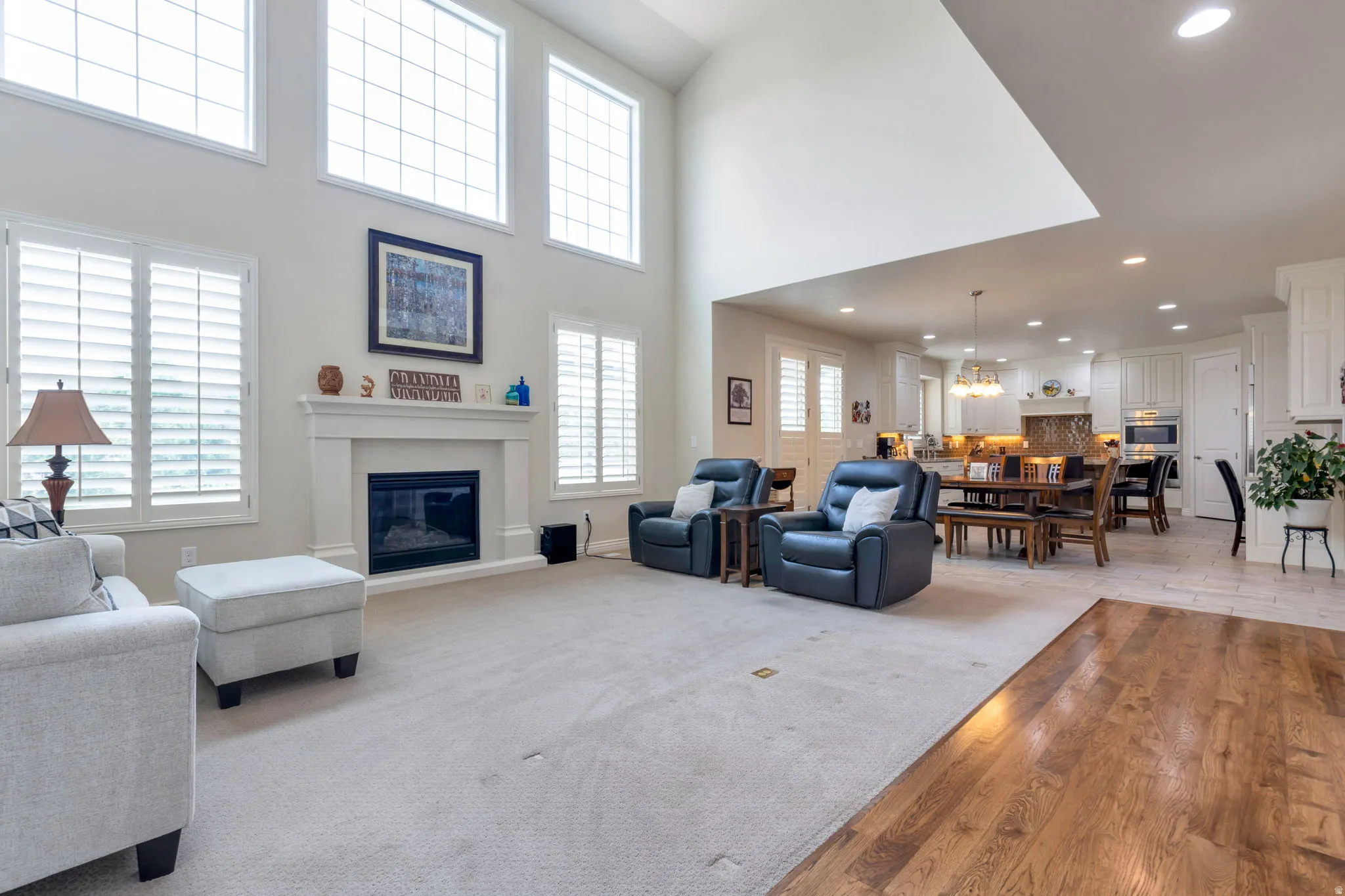 Open-concept living space featuring a two-story vaulted ceiling