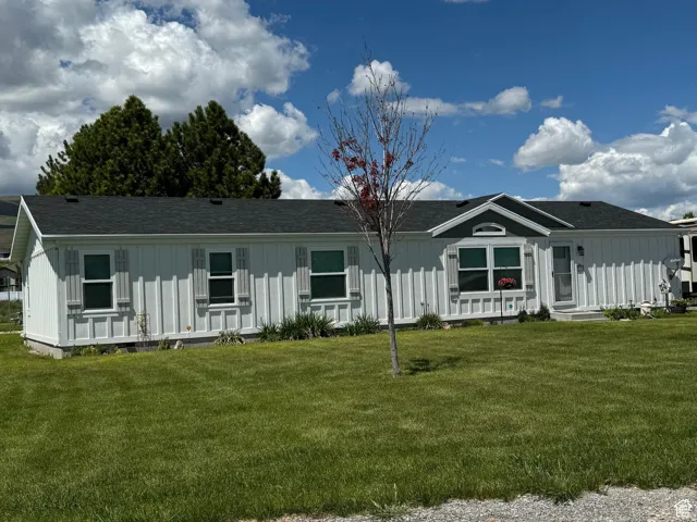 Single-story residence featuring white board-and-batten style siding