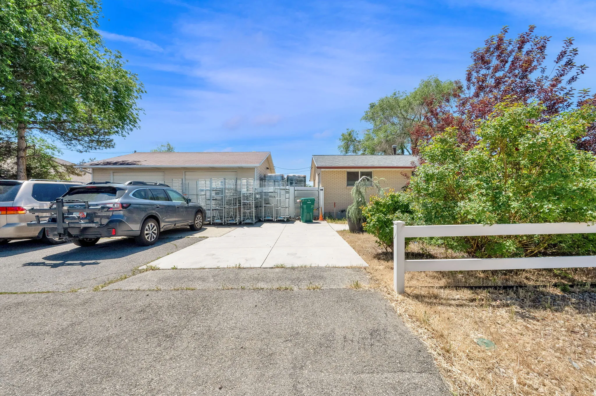 Asphalt parking area with an adjacent concrete pad l