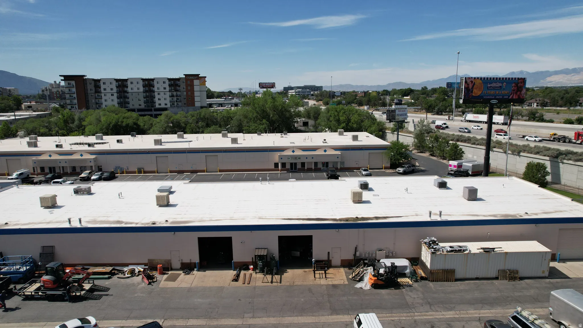 Commercial building featuring multiple loading dock doors and a flat roof